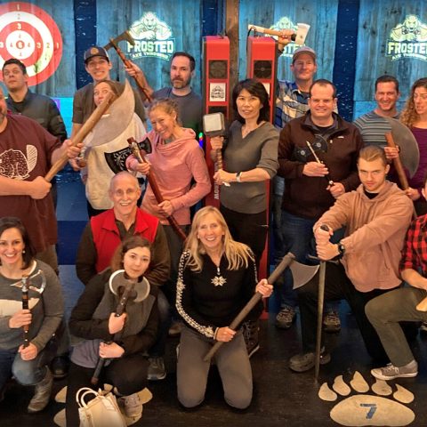 a group of people standing in front of a crowd posing for the camera