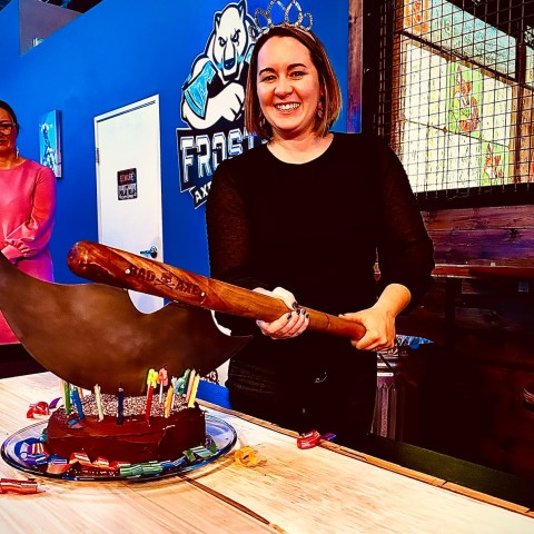 a person standing in front of a cake